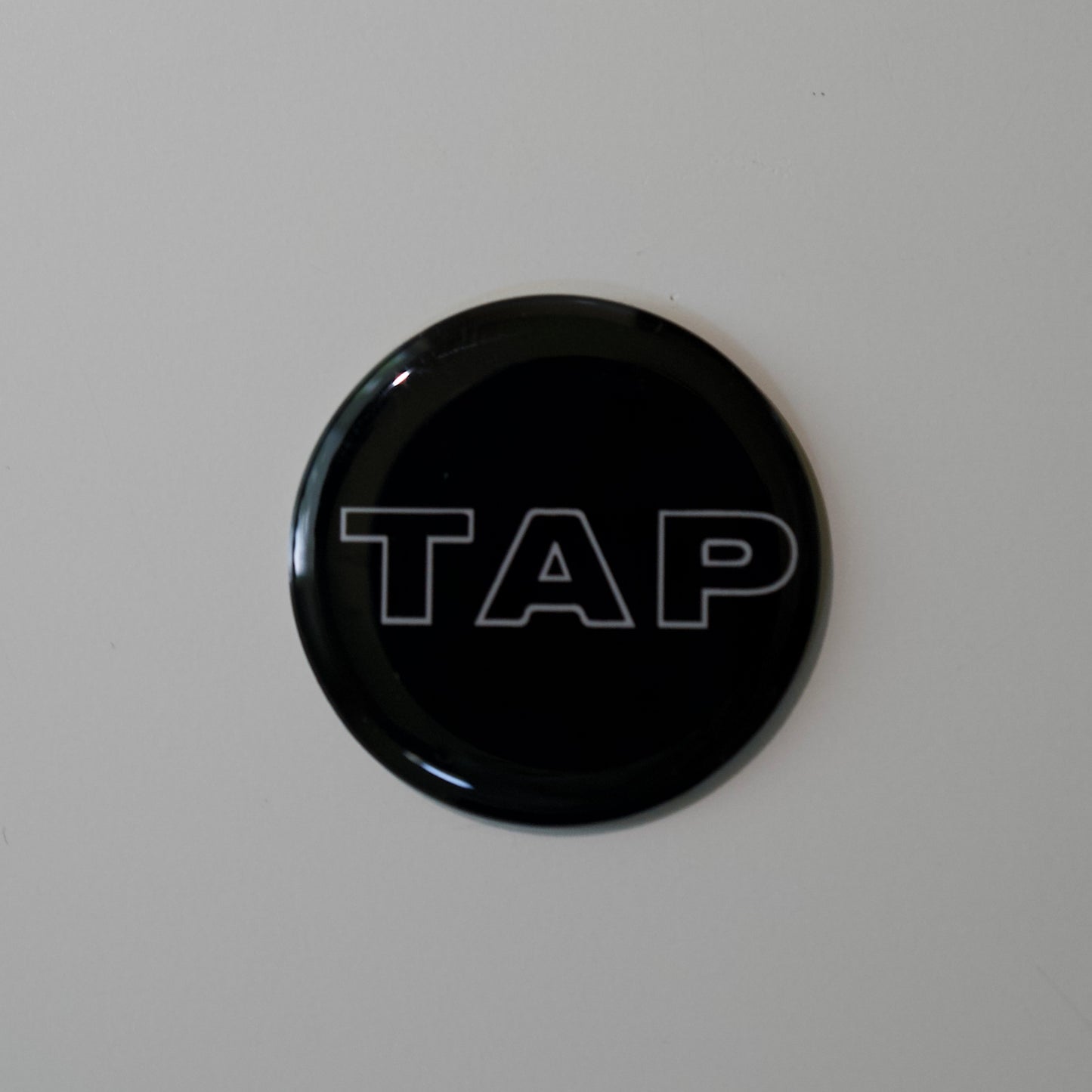 Close-up image of a Tap Networking NFC business tag, featuring sleek design and embedded NFC chip for quick contact sharing in professional networking