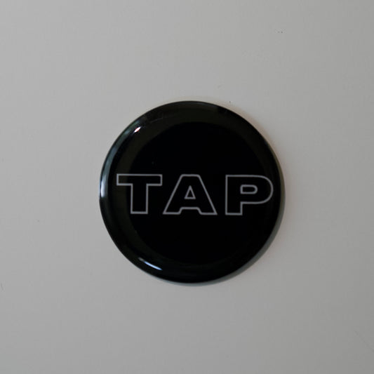 Close-up image of a Tap Networking NFC business tag, featuring sleek design and embedded NFC chip for quick contact sharing in professional networking
