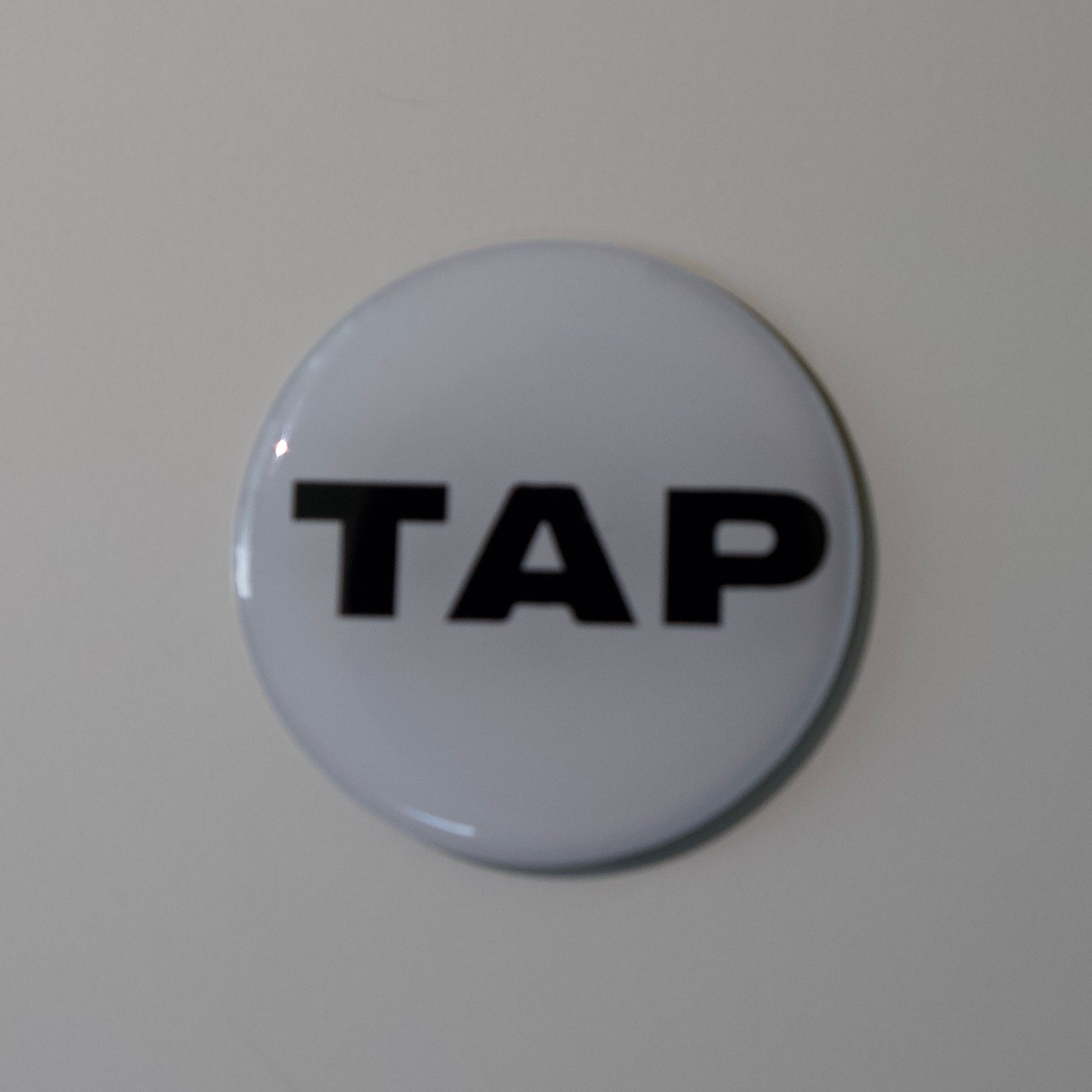 Close-up image of a Tap Networking NFC business tag, featuring sleek design and embedded NFC chip for quick contact sharing in professional networking