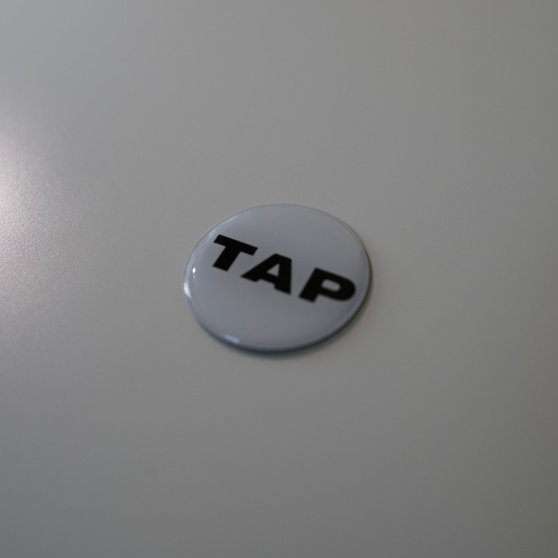 Close-up image of a Tap Networking NFC business tag, featuring sleek design and embedded NFC chip for quick contact sharing in professional networking