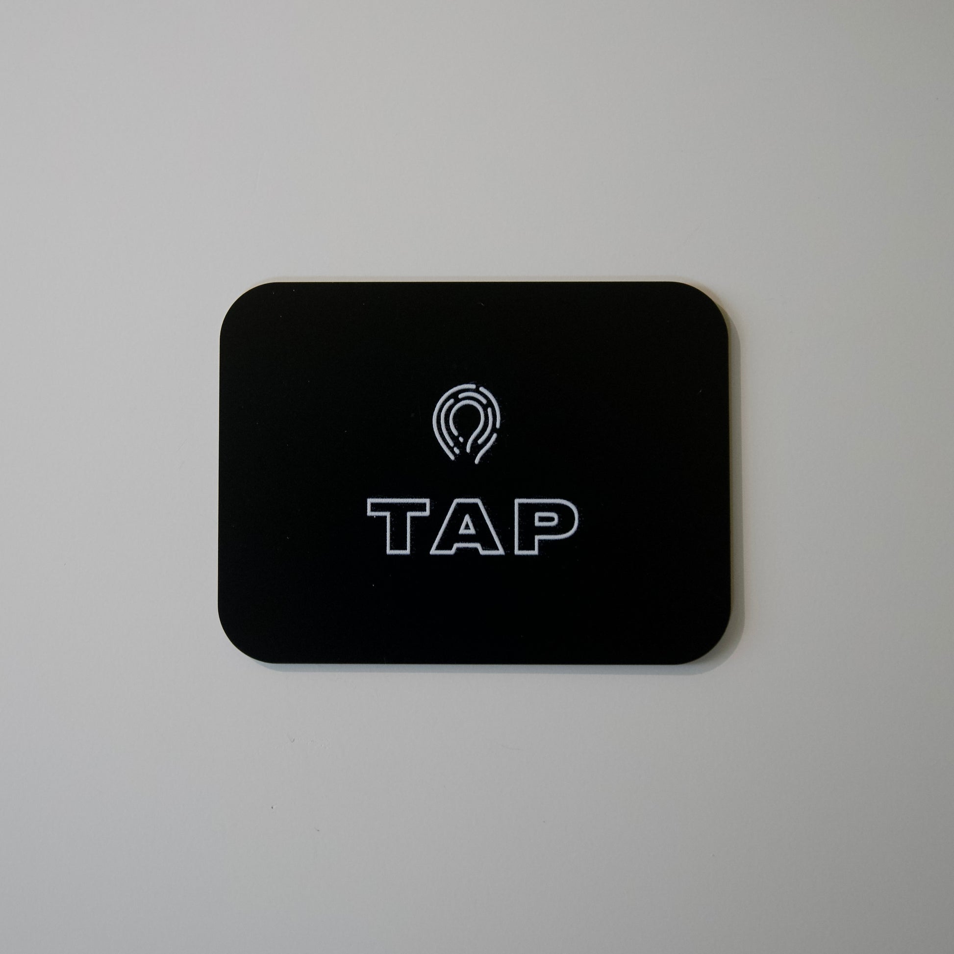 Close-up image of a Tap Networking NFC business card, featuring sleek design and embedded NFC chip for quick contact sharing in professional networking