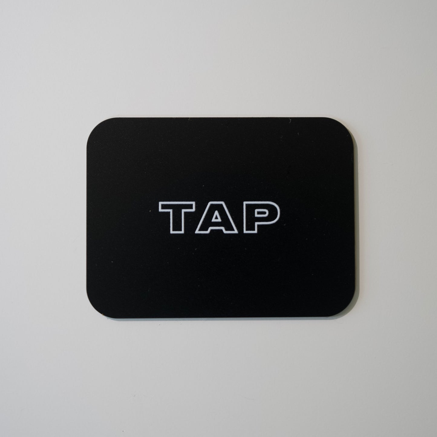 Close-up image of a Tap Networking NFC business card, featuring sleek design and embedded NFC chip for quick contact sharing in professional networking